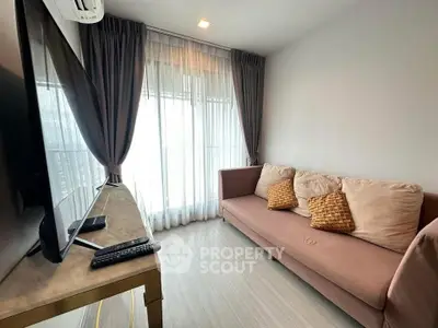 Cozy living room with modern sofa and large window for natural light