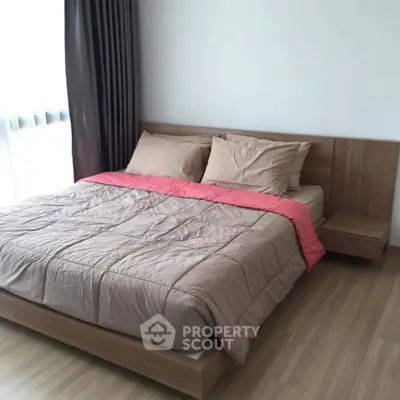 Modern bedroom with wooden flooring and stylish bed in a bright apartment