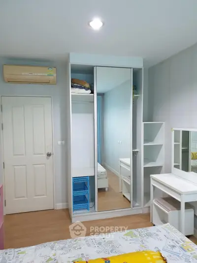 Modern bedroom with mirrored wardrobe and stylish decor
