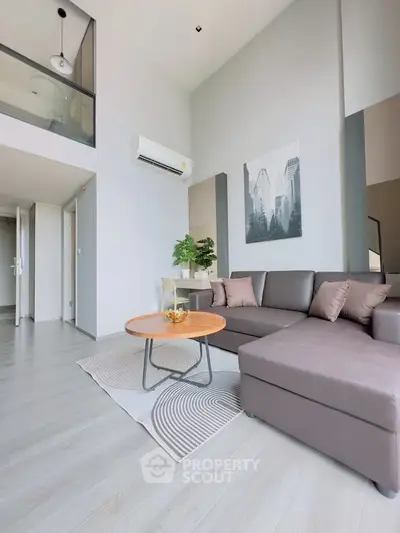 Modern living room with stylish decor and comfortable seating in a bright apartment.