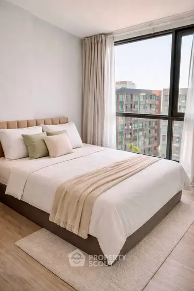 Modern bedroom with large window and city view, featuring elegant decor and cozy bedding.