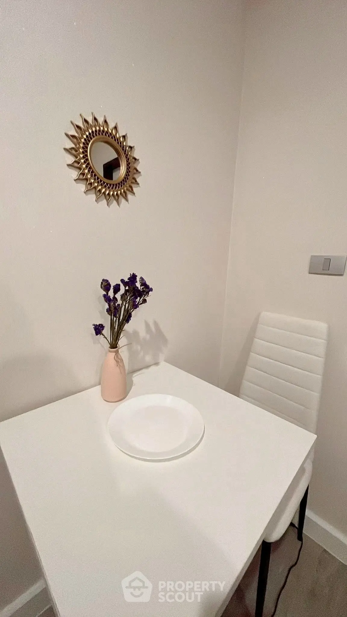Cozy dining nook with modern decor and elegant white table setting.