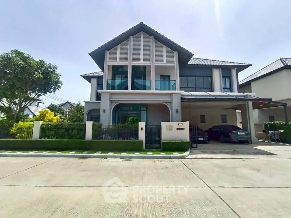Modern two-story house with carport and landscaped front yard in a suburban neighborhood.