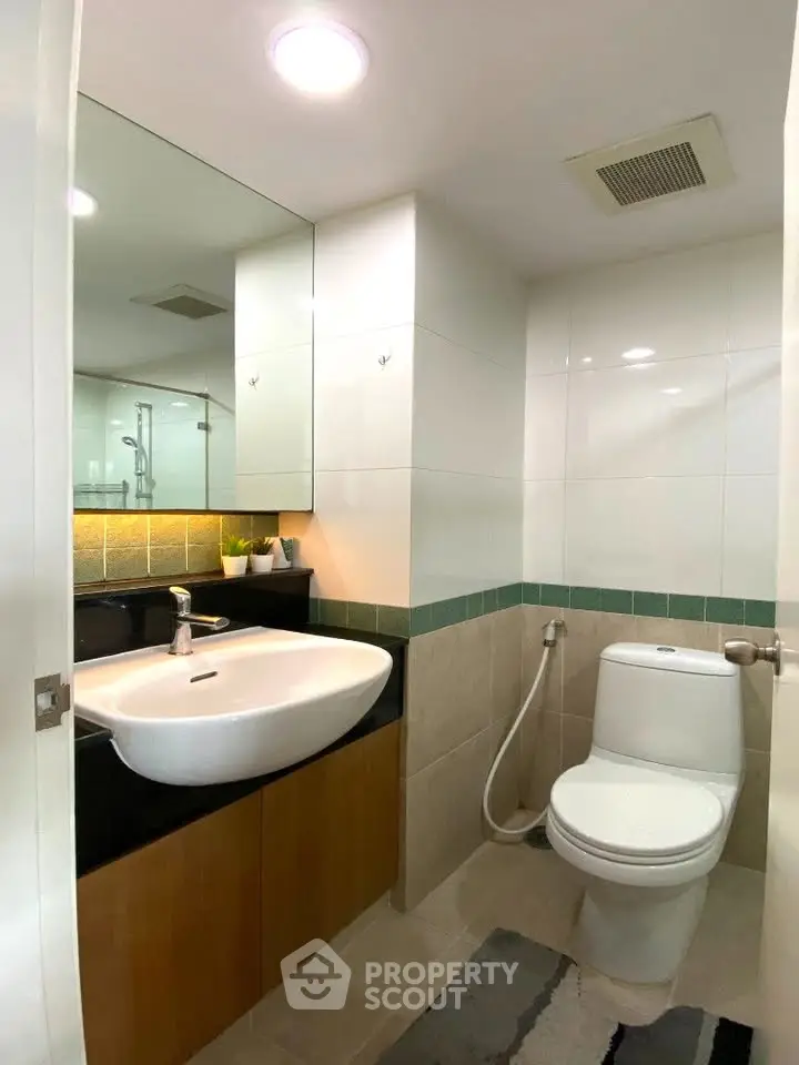 Modern bathroom with sleek fixtures and stylish lighting in a contemporary apartment.