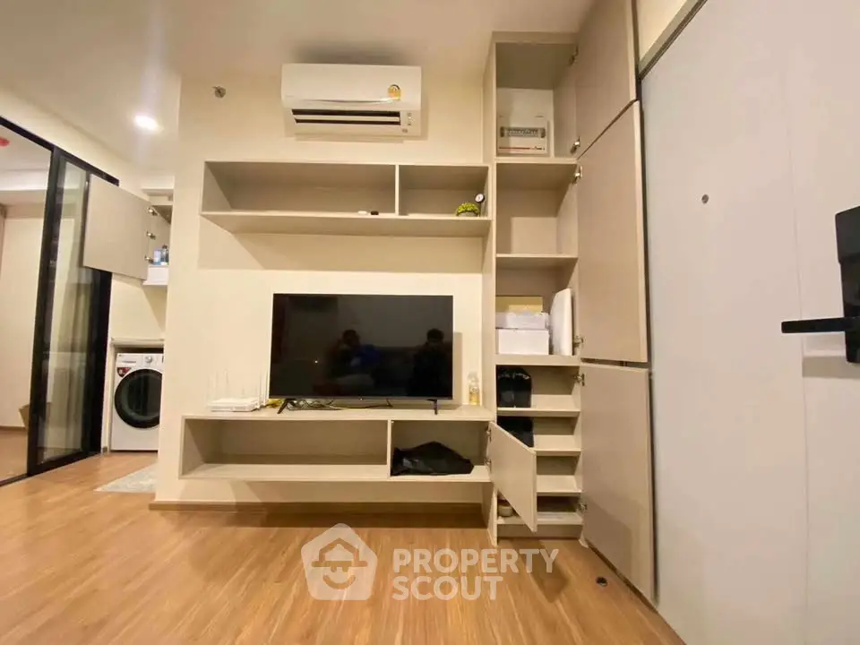 Modern living room with built-in storage and sleek wooden flooring
