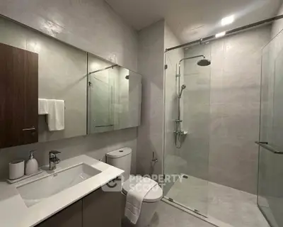 Modern bathroom with sleek shower and elegant fixtures in a contemporary home.