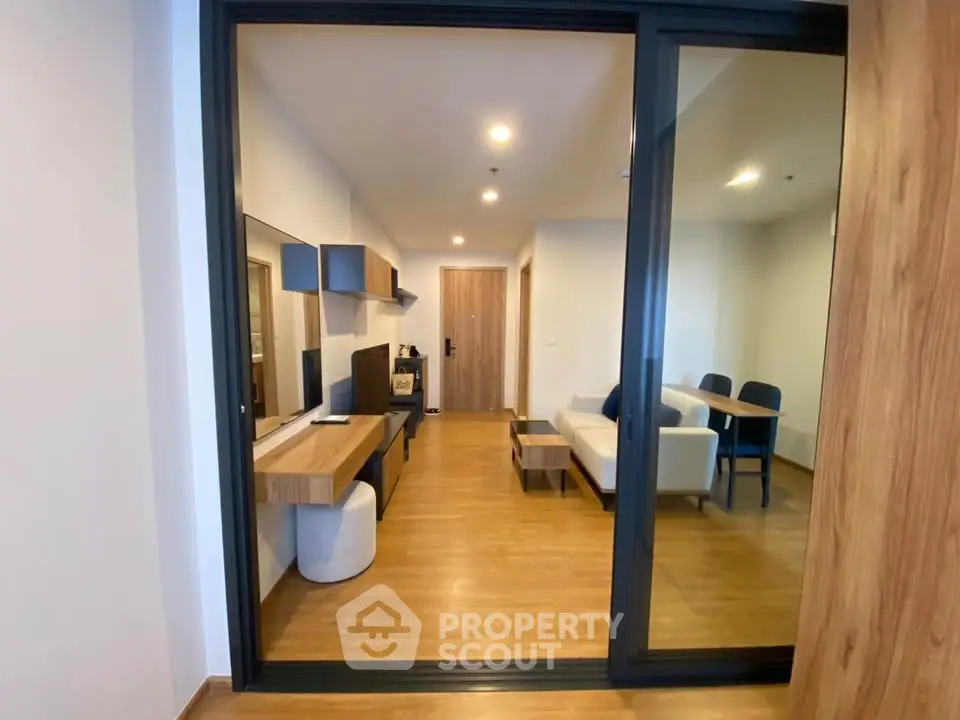 Modern living room with wooden flooring and stylish furniture in a cozy apartment.