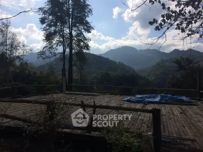 Scenic mountain view from a rustic wooden deck, perfect for nature lovers seeking tranquility.