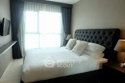 Modern bedroom with large window and elegant decor