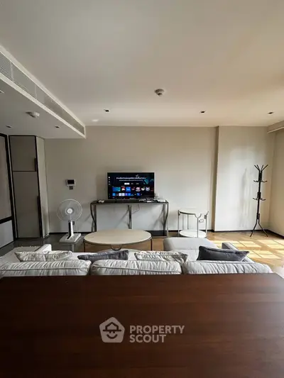 Spacious modern living room with sleek furniture and entertainment setup