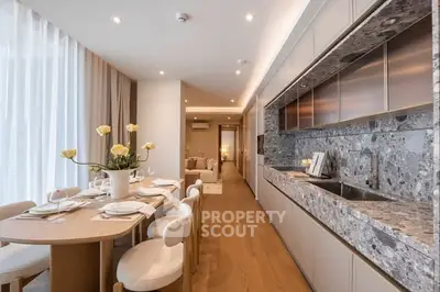 Luxurious open-plan kitchen and dining area with elegant decor and modern appliances.
