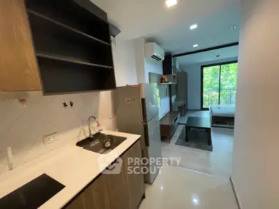 Modern studio apartment with open kitchen and scenic view