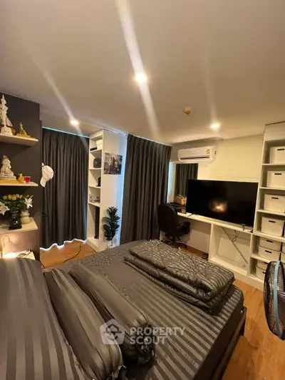 Modern bedroom with stylish decor, built-in shelves, and workspace setup