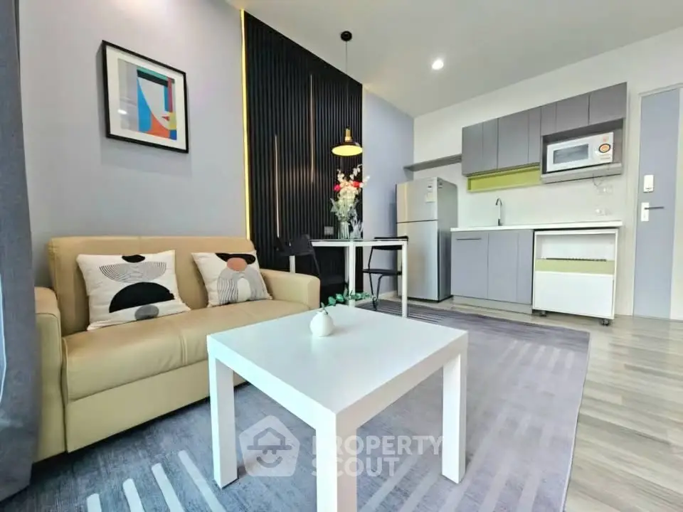Modern open-layout living room with stylish kitchen and cozy sofa