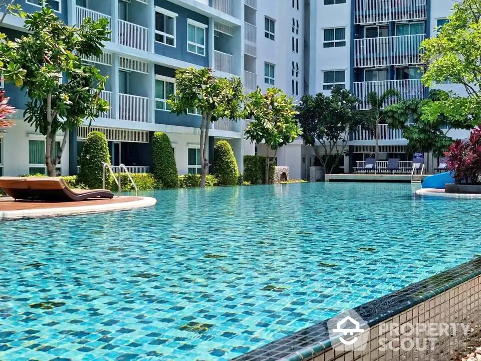 Luxurious condominium with stunning outdoor pool and lush greenery.