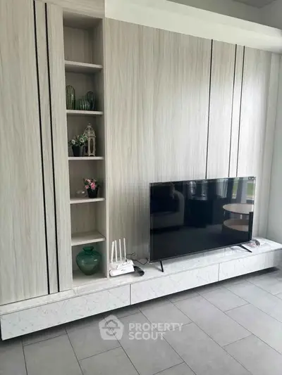 Modern living room with sleek TV unit and decorative shelves