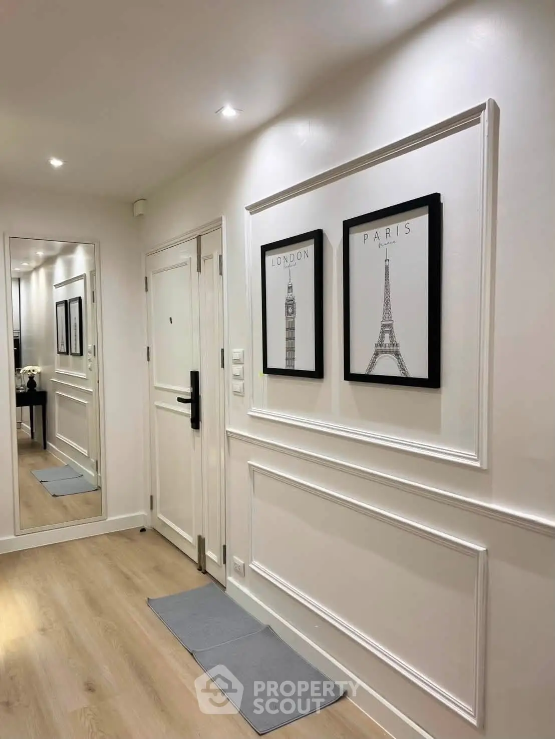 Elegant hallway with stylish decor and wooden flooring in modern apartment.