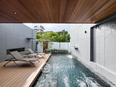 Luxurious modern pool area with sleek design and wooden deck