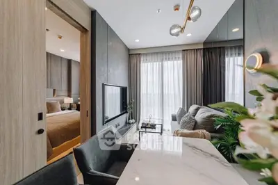 Modern open-plan living room with elegant decor and natural light