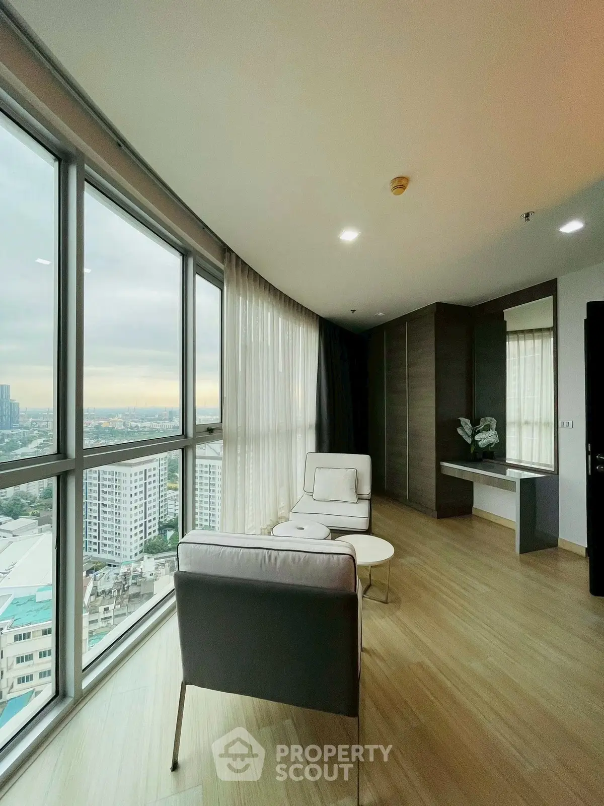 Modern high-rise apartment with panoramic city views and stylish interior design.