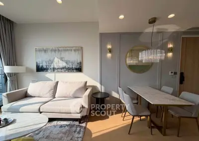 Elegant living and dining area with modern decor and natural light