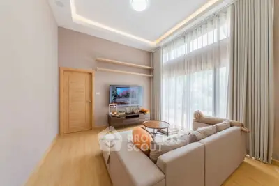 Spacious living room with modern decor and large windows for natural light.