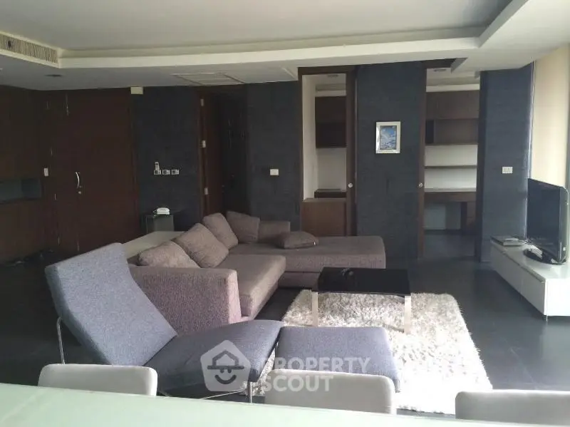 Spacious modern living room with sleek furniture and cozy ambiance.