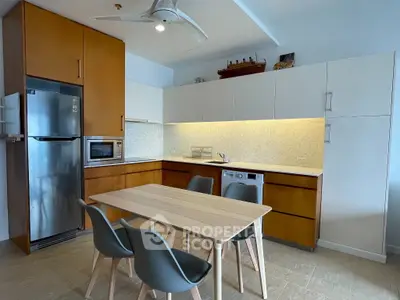 Modern kitchen with sleek cabinetry, stainless steel appliances, and a stylish dining area.