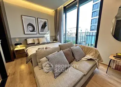 Modern bedroom with cozy sofa and balcony view in urban apartment