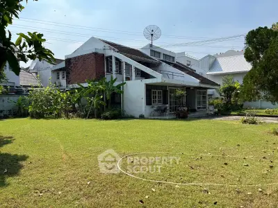 Charming suburban house with spacious garden and unique architectural design.