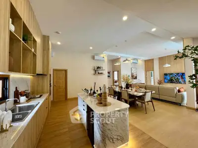 Spacious open-plan kitchen and living area with modern decor and ample natural light.