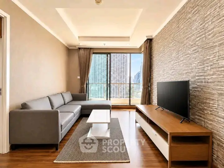 Modern living room with stylish decor and city view, featuring a sleek sofa and entertainment unit.