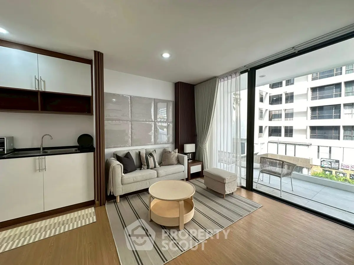 Modern living room with large windows and stylish decor in a city apartment