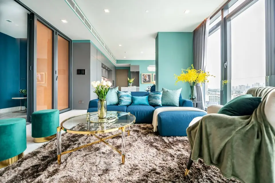 Luxurious modern living room with plush seating and panoramic city views.
