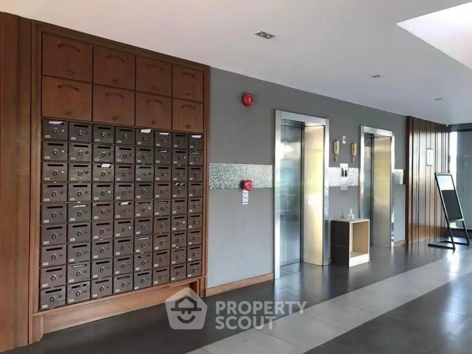 Modern apartment building entrance with mailboxes and elevators
