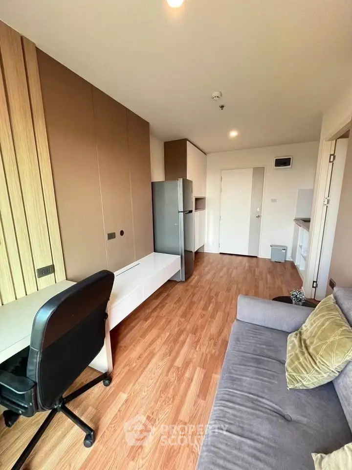 Modern living room with wooden flooring and stylish furniture in a cozy apartment.