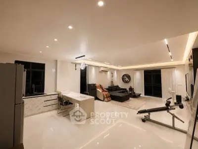 Spacious modern living room with open kitchen and sleek design