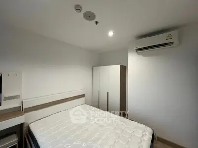 Modern bedroom with minimalist design featuring a comfortable bed, wardrobe, and air conditioning unit.