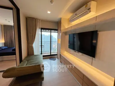 Modern living room with city view, stylish furniture, and wall-mounted TV in a high-rise apartment.