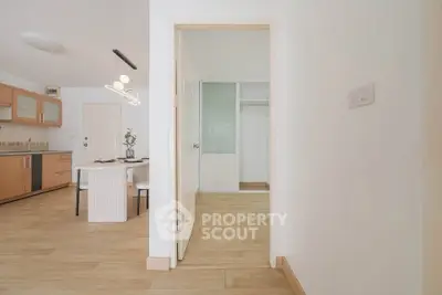 Modern open-plan kitchen and dining area with wooden flooring and minimalist design.