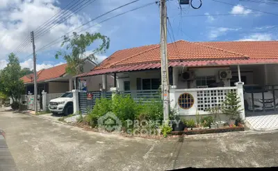 Charming suburban homes with red-tiled roofs and lush greenery in a peaceful neighborhood.
