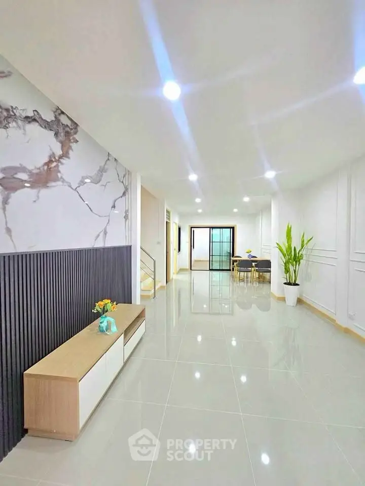 Spacious modern living room with elegant decor and ample natural light.