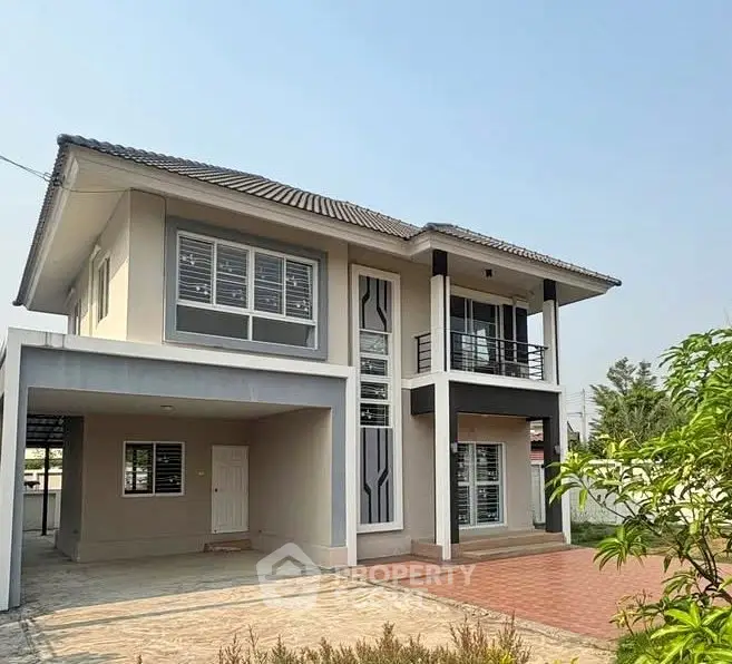 Modern two-story house with spacious driveway and stylish facade.