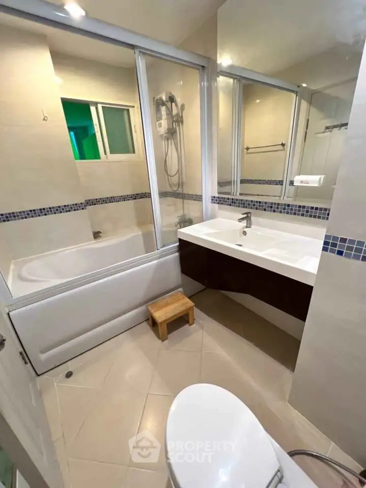 Modern bathroom with bathtub and sleek fixtures in a contemporary apartment.