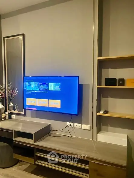 Modern living room with wall-mounted TV and sleek furniture design