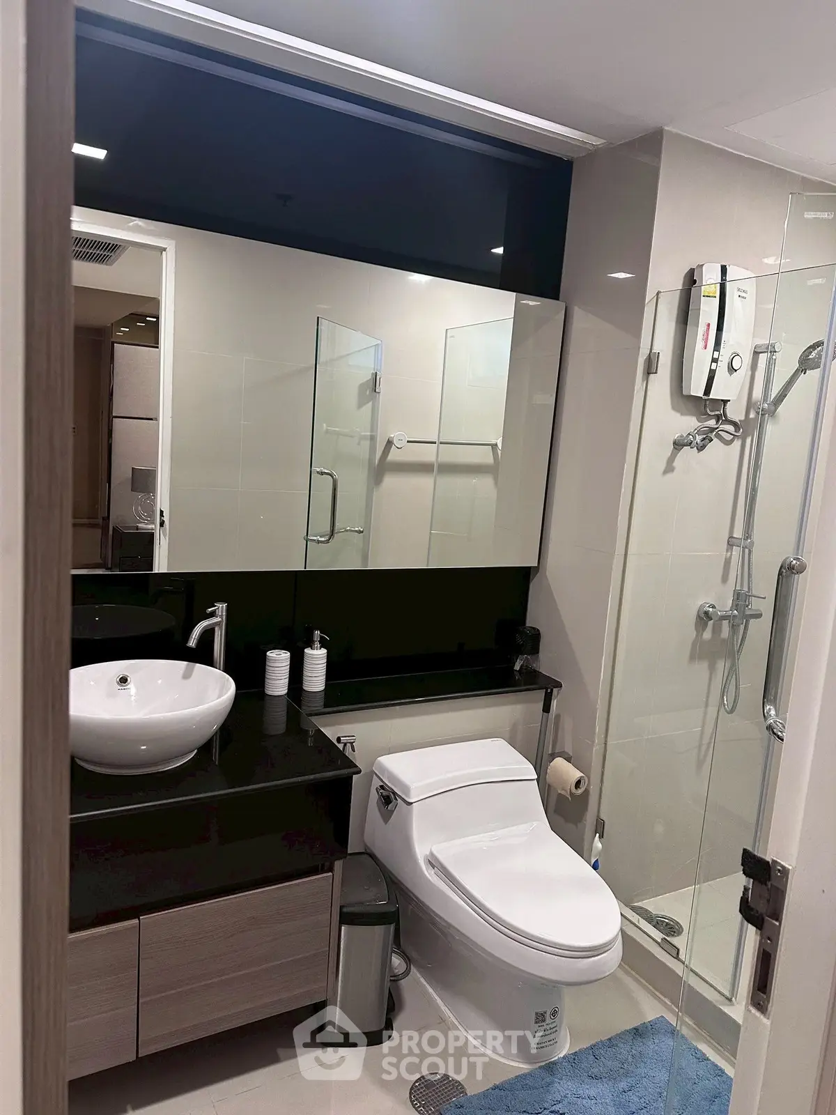 Modern bathroom with sleek fixtures and glass shower enclosure