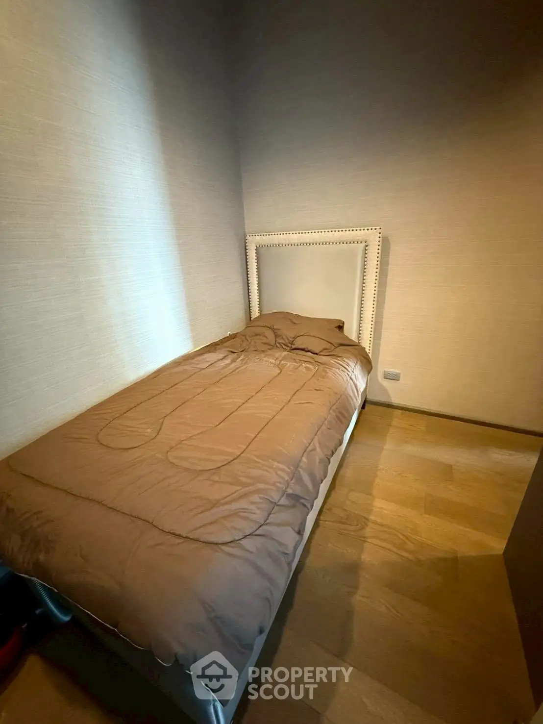 Cozy minimalist bedroom with single bed and warm lighting