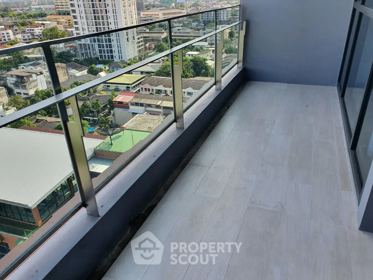 Spacious balcony with city view in modern high-rise apartment