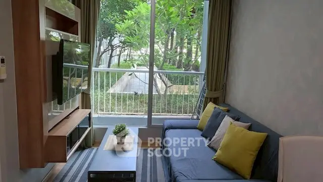 Charming living room with garden view, modern decor, and cozy seating area.