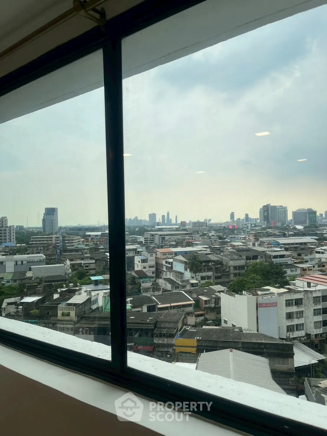 Stunning cityscape view from high-rise window showcasing urban skyline and vibrant city life.